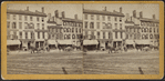 Commercial street with printer, insurance company, and hotel.