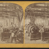 Men in an unidentified mill showing belt driven equipment.