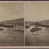 View of the centennial flood innudating the railroad bridge.