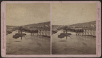 View of the centennial flood innudating the railroad bridge.