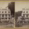 View of men working on the foundation of a house.