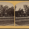 Women in a garden with trees.