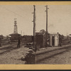 View of a railroad yard showing switches and tower.