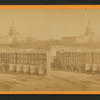 View of U.S. Capitol, with a row of homes in the foreground.