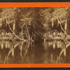 View of people on the banks of a river.