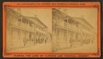 View of people in their balconies in a residential street.