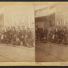 View of African American shoe shine boys posing along the streetcar tracks.