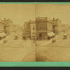 iew on Washington Street [a commercial street with stores, street car and carts.]