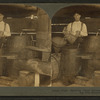 View of men pouring turpentine into barrels.