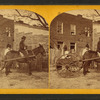 View of a man in mule cart in front of a home.
