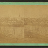 Elgin: general view showing churches, river, homes, a home with trees in the yard in bloom, a street view showing covered wagon.