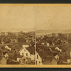 General view of Moline, Illinois showing homes, businesses and Mississippi River.