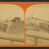 View of train wreck on bridge.