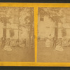Group portrait of people in front of a cottage. 