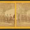 Group portrait of men in front of a tent.
