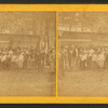 Group portrait of people in front of a cottage.