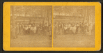 Group portrait of people in front of a cottage.