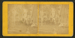 Group portrait of people in front of cottages.