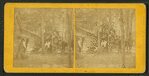Group portrait of people in front of cottage, including furniture in a moving wagon.