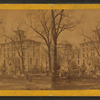 View of people in yard of building that may be a home.