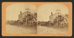 Workers and buggies in front of buggy shop.