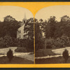 Winding path leads to church set among trees.