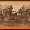 Couple sitting in front of their home with child standing, Waterloo, Iowa.