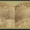 The stone pile that marks the grave of the Gardner family, massacared in 1857 and the cabin in the background.