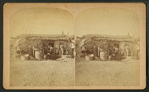 Family in front of a sod house.