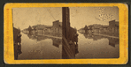 Wooden houses along a flooded Main street.