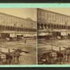 General street view, showing horse-drawn buggies.