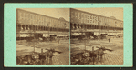 General street view, showing horse-drawn buggies.