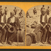 Two African American men sitting on barrels on the levee.
