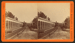 Western Maryland Railraod train standing next to covered platform lined with benches, sign at right reads "Pennsylvania."