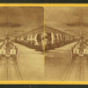 Interior of the armory showing rifles, cutlasses, carbines and howitzers.