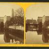 View of buildings lining the banks of an unidentified body of water, possibly Jones Falls.]