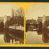 View of buildings lining the banks of an unidentified body of water, possibly Jones Falls.