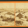 Commercial buildings with city in background.