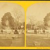 Men and women posing around unidentified fountain.