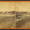 People standing in area ruined by the flood.