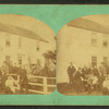 Extended family (?) posed outside of house near fence.