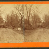 View of people alongside a flood-damaged road.
