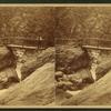 View of a man on a bridge at Bash Bish.