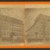 A group of men outside of a large building.