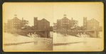 Westbrook Manufacturing Company, showing buildings on a river and part of a bridge.