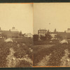 View of a farm in Clinton with plants in foreground, a home, and barns.