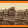Street view in Clinton showing book store, ice cream shop buggies, and construction in the foreground.