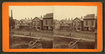 Street view in Clinton showing book store, ice cream shop buggies, and construction in the foreground.