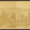 Men standing among debris of a ruined building in Southbridge.