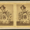View of a photograph surrounded by a memorial wreath.